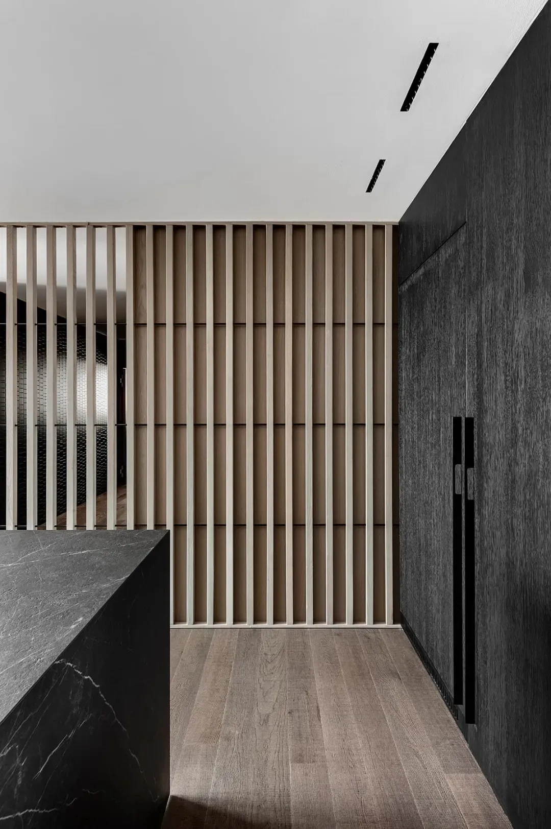 Modern kitchen featuring marble countertops and wooden accents