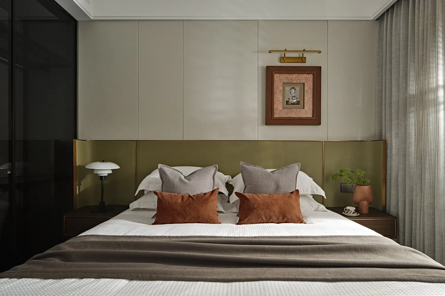 Contemporary bedroom with modern furniture, featuring fabric upholstery and minimalist design.