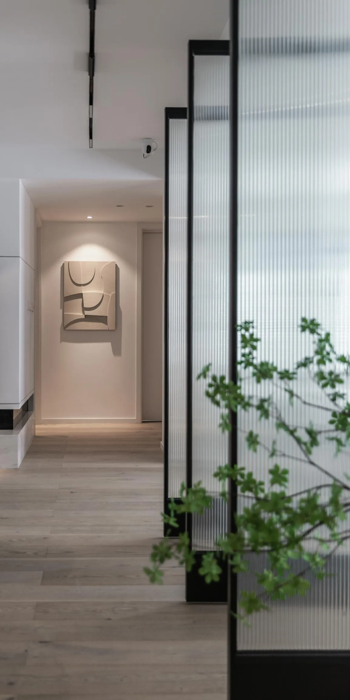 A modern entryway featuring a glass panel, minimalist design, and a soft, ambient light. Includes a sleek floor plan and cont