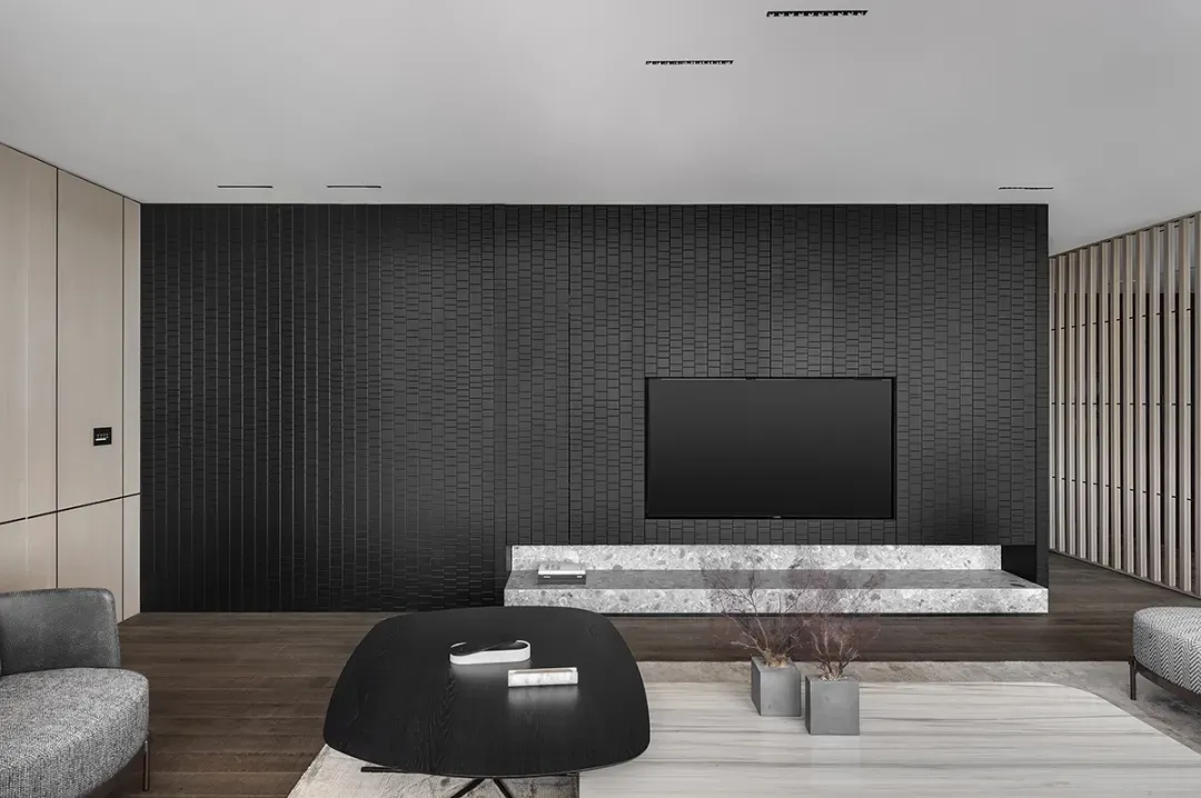 Modern minimalist living room featuring marble and metal accents