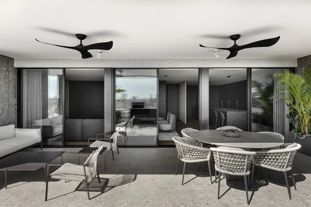 Modern living room with concrete, glass, and metal accents.