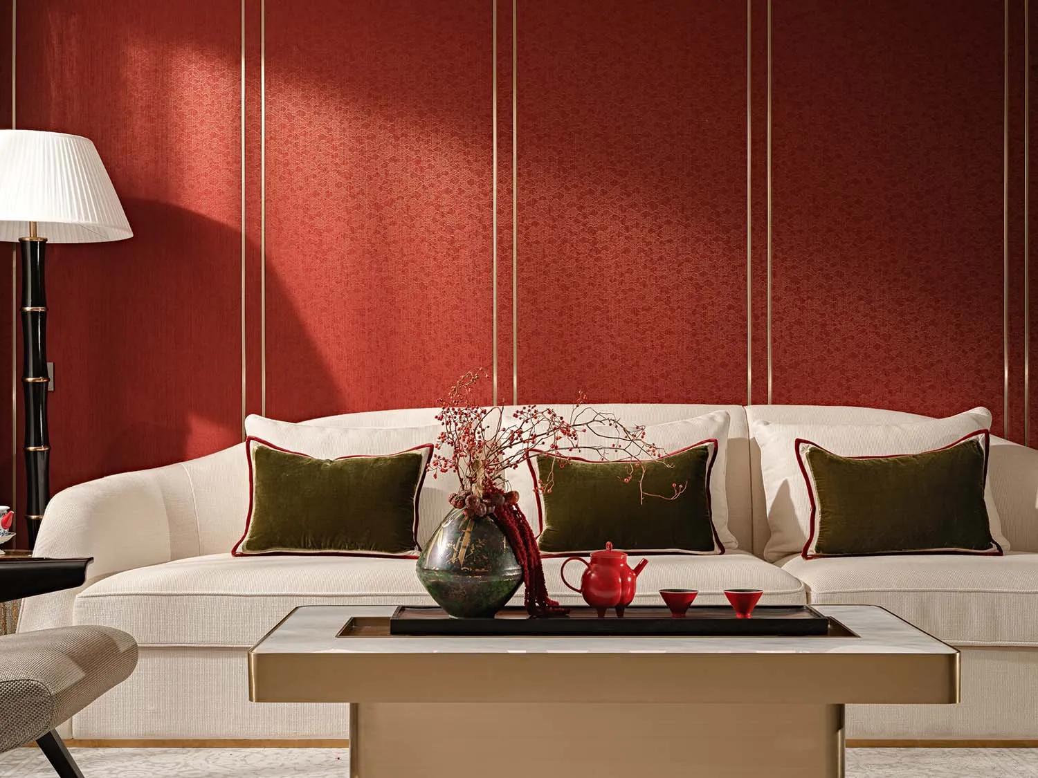 A stylish modern living room featuring a white sofa adorned with plush cushions and a coffee table displaying decorative item