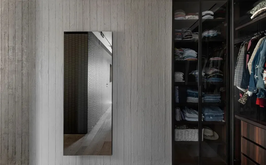 A modern wardrobe featuring glass and wooden elements.