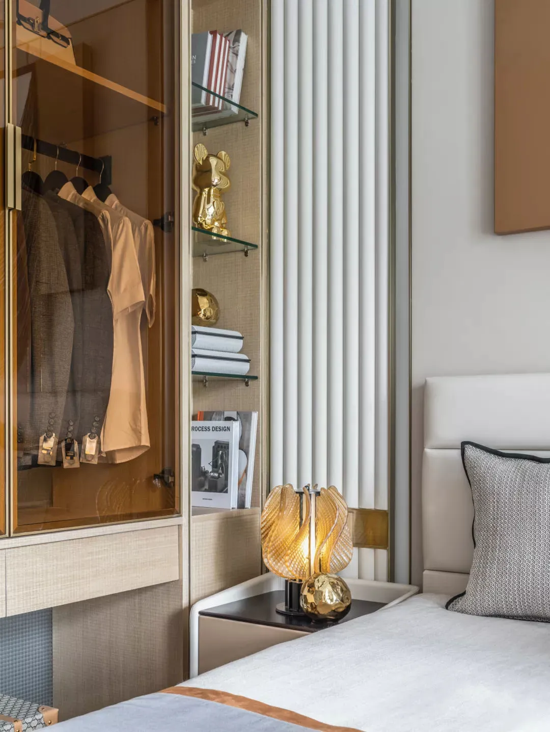 A minimalist bedroom featuring a modern style with a white bed, gold accents, and white and gold decor.