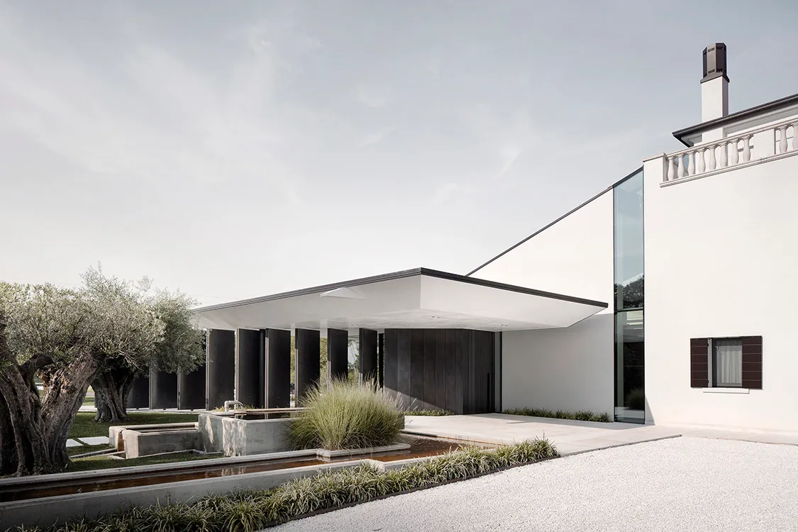 Modern exterior design featuring a minimalist architectural style with concrete and glass materials.