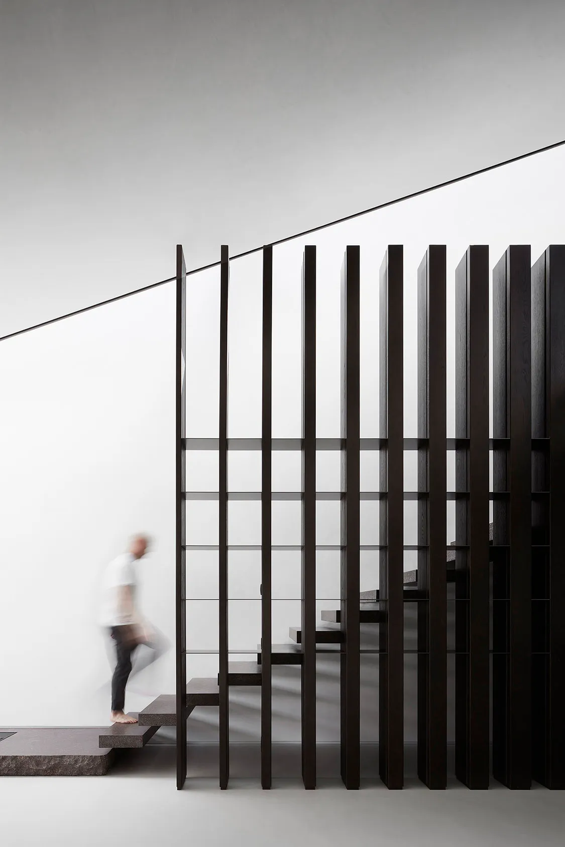 Modern interior staircase featuring glass and metal materials