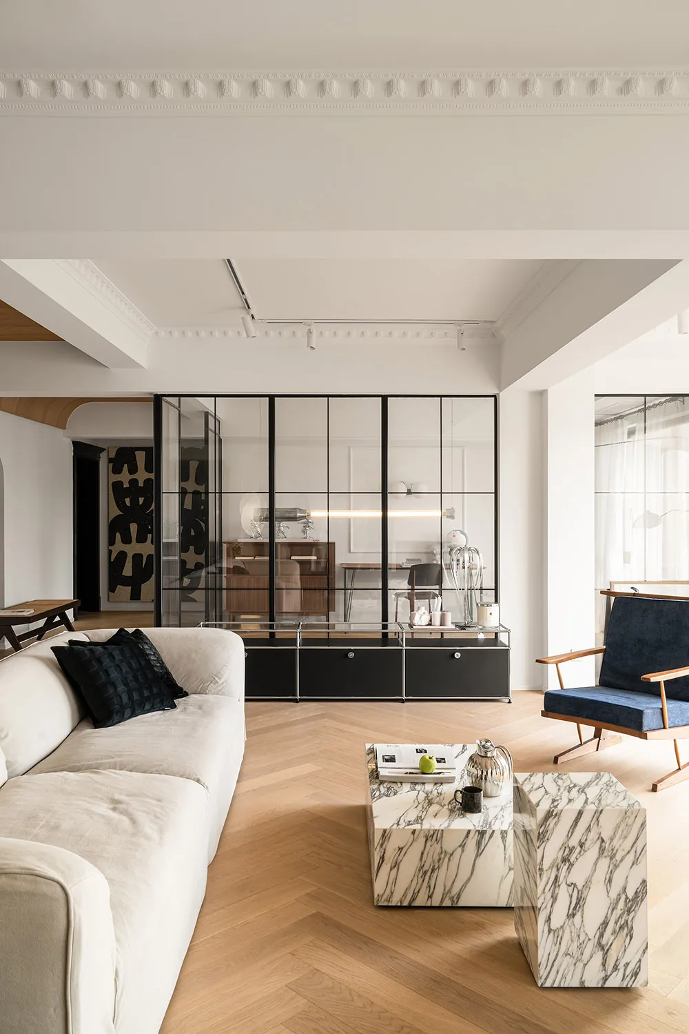 Modern living room featuring marble coffee tables and wood flooring
