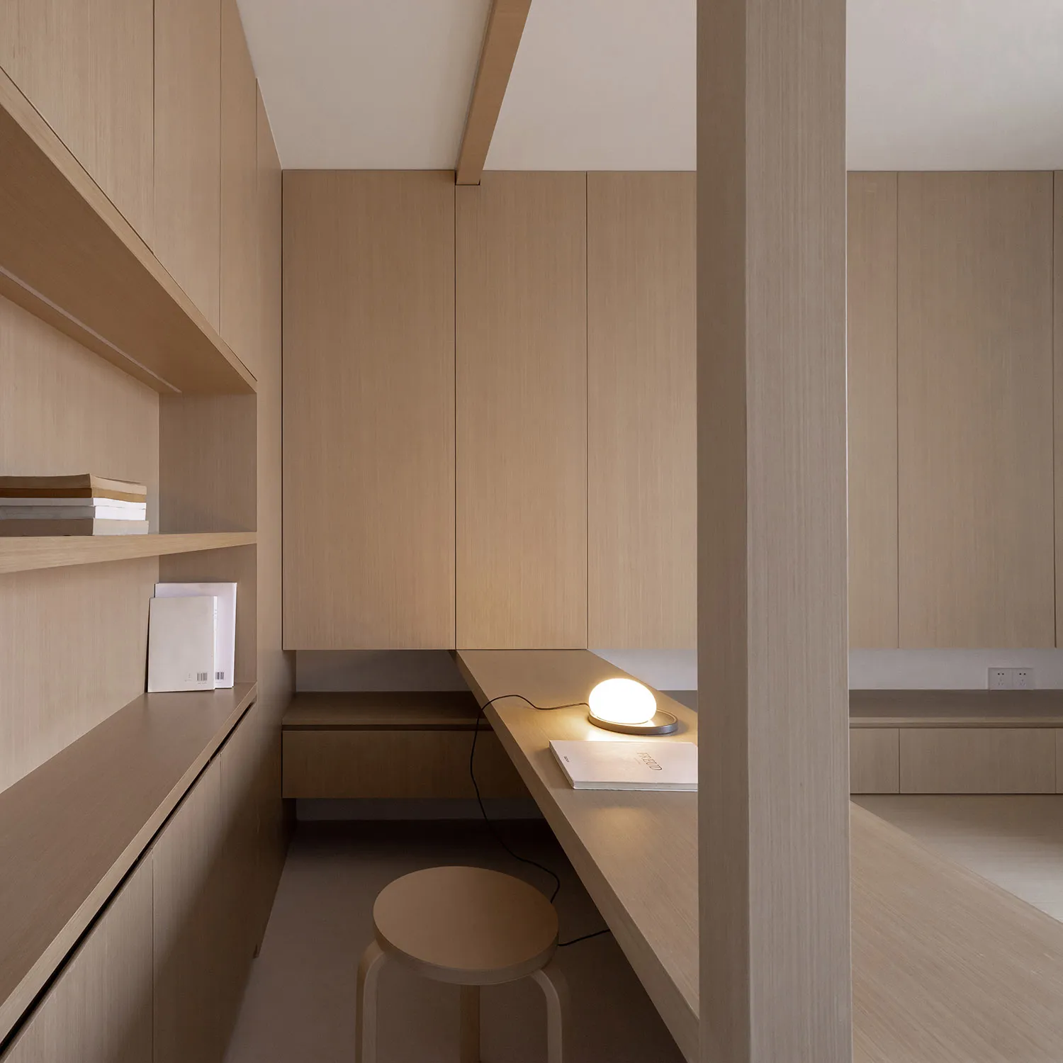 Minimalist residential office space featuring wooden design elements.