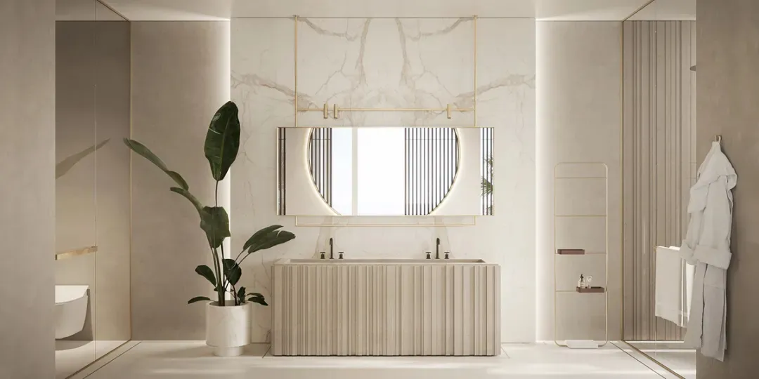 Modern bathroom featuring white marble walls, a double sink vanity, a hanging round mirror, and a potted plant