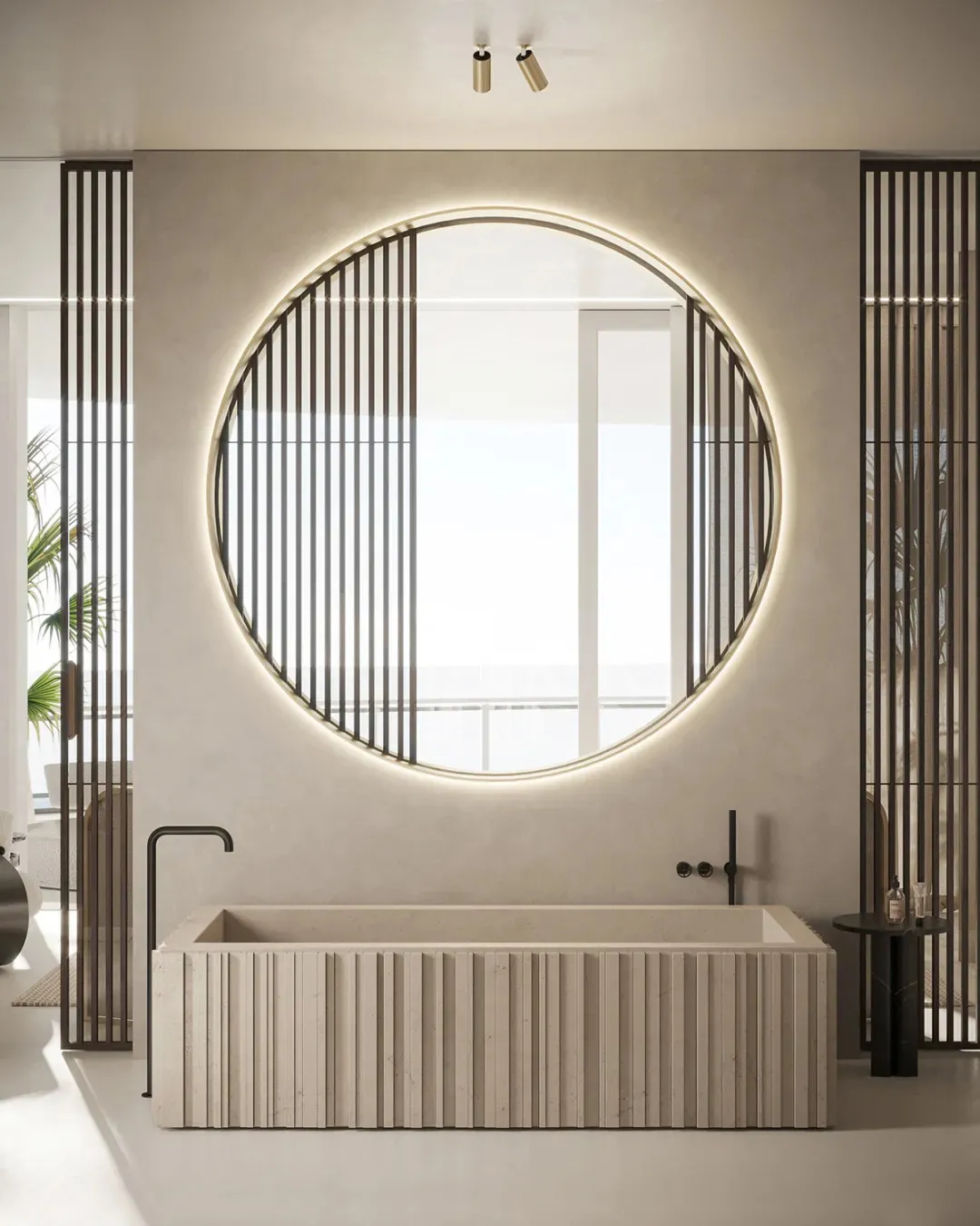 A modern bathroom interior featuring a white marble bathtub and a large round mirror with backlighting.