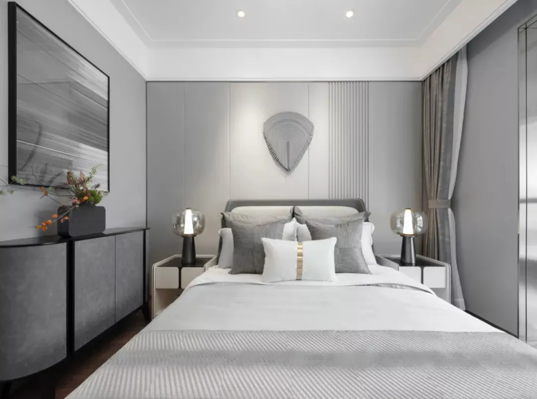 A modern bedroom featuring textured fabric bedding and walls, with minimalistic decor and a sleek, contemporary design.