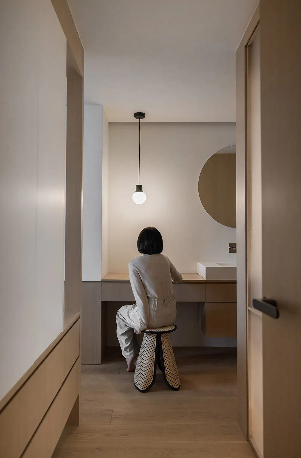 A minimalist bathroom with concrete walls and wooden elements