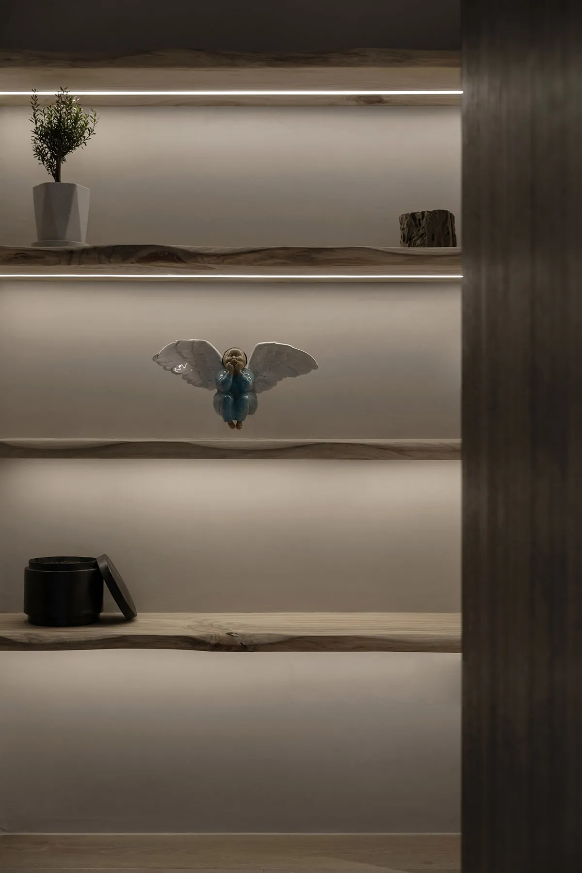 A modern shelf display featuring wooden shelves with built-in lighting.