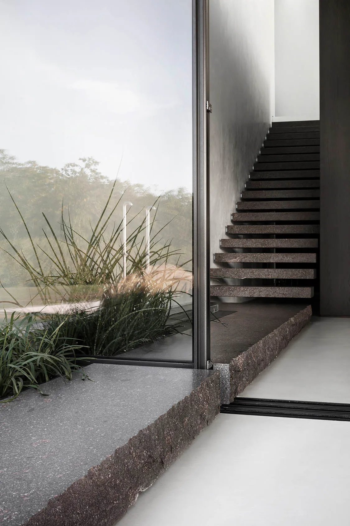 Modern stairs constructed from granite material outdoors.