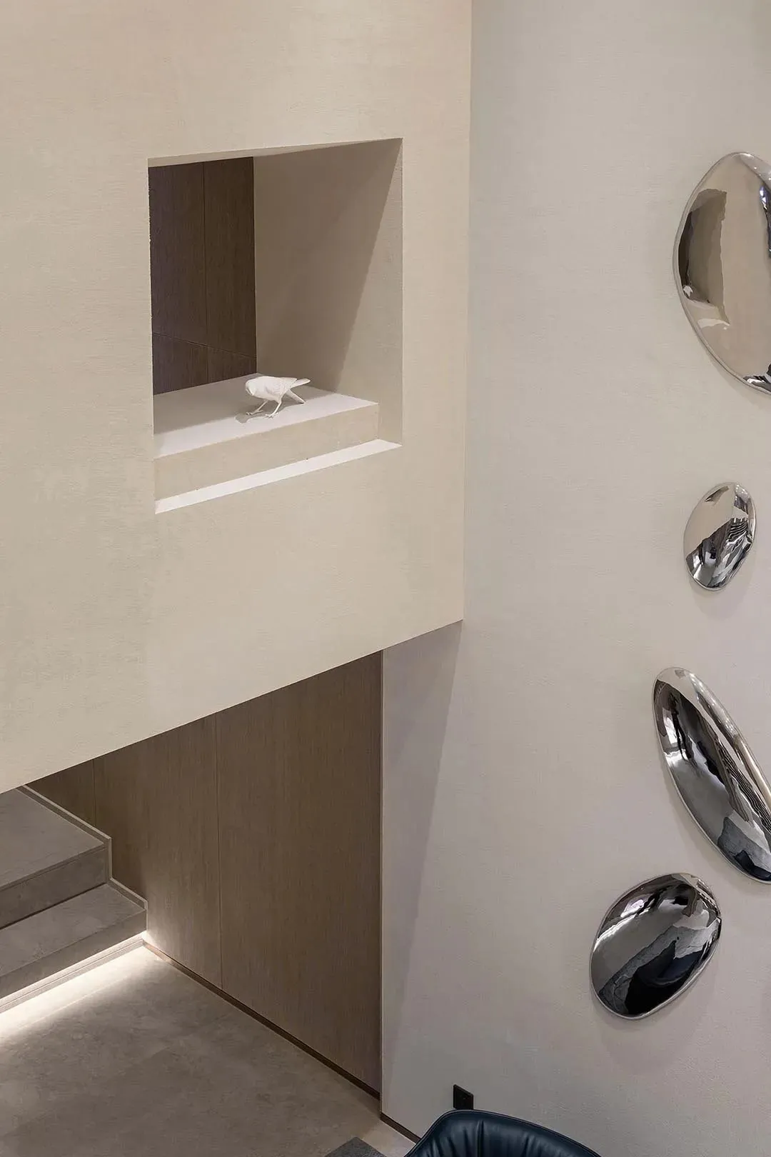 A minimalist entryway featuring concrete materials and geometric shapes.
