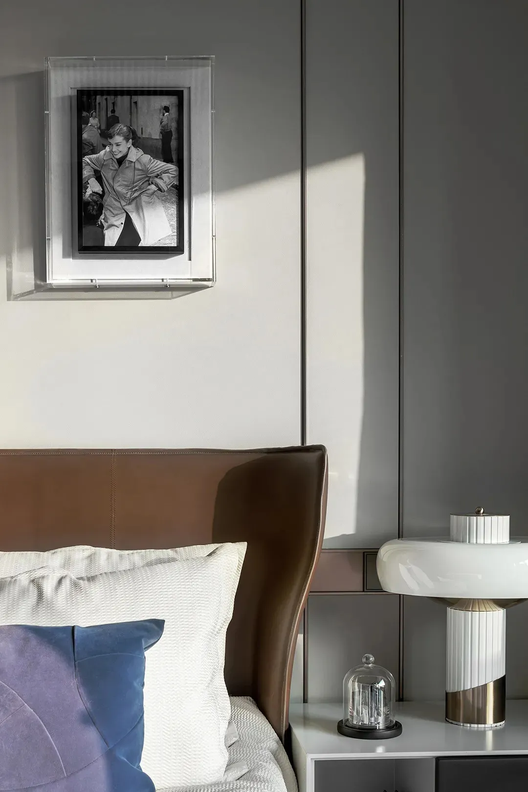 Modern bedroom featuring a sleek acrylic nightstand with a minimalist design.