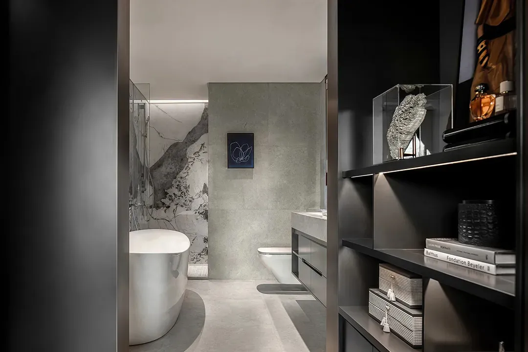 Modern bathroom featuring white marble walls and a freestanding bathtub.