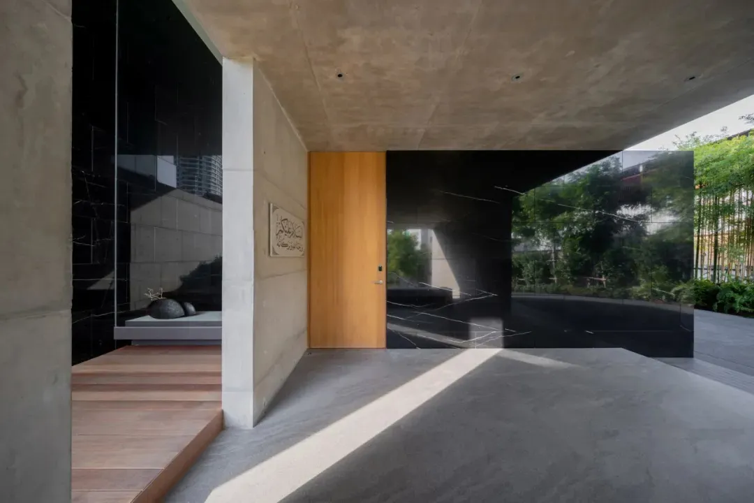 Entryway featuring concrete and glass materials with a minimalist design.