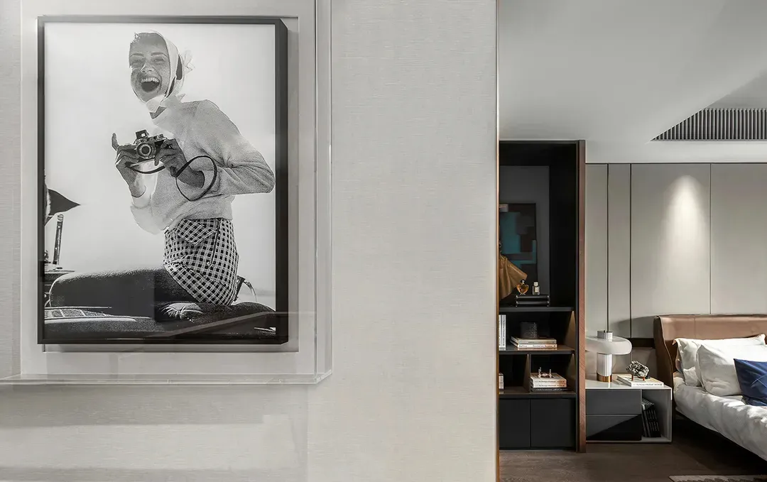 Modern bedroom with minimalist design featuring neutral-toned furniture and a cozy atmosphere.
