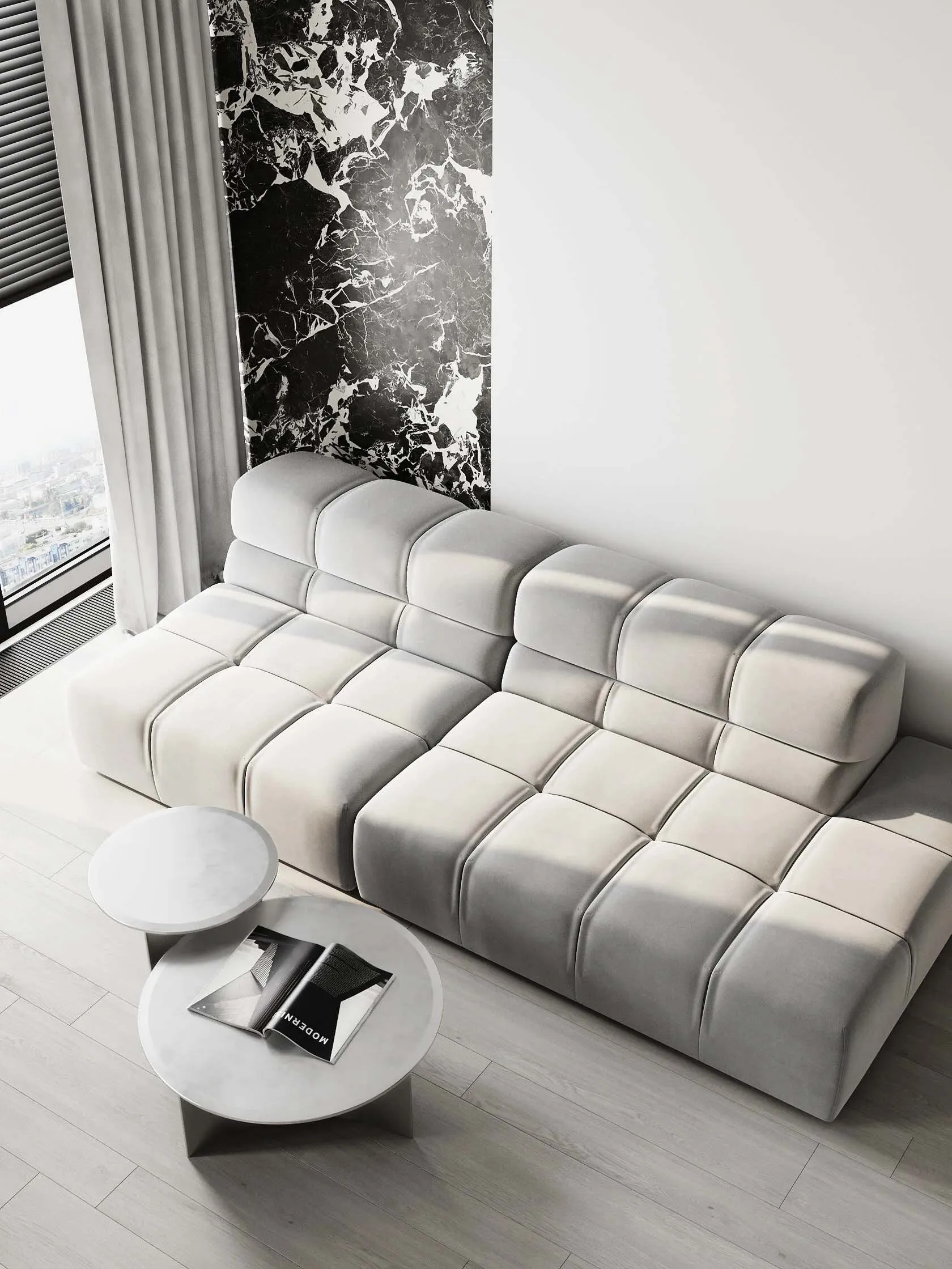 White modular sofa with tufted cushions in a modern living room featuring marble accents.