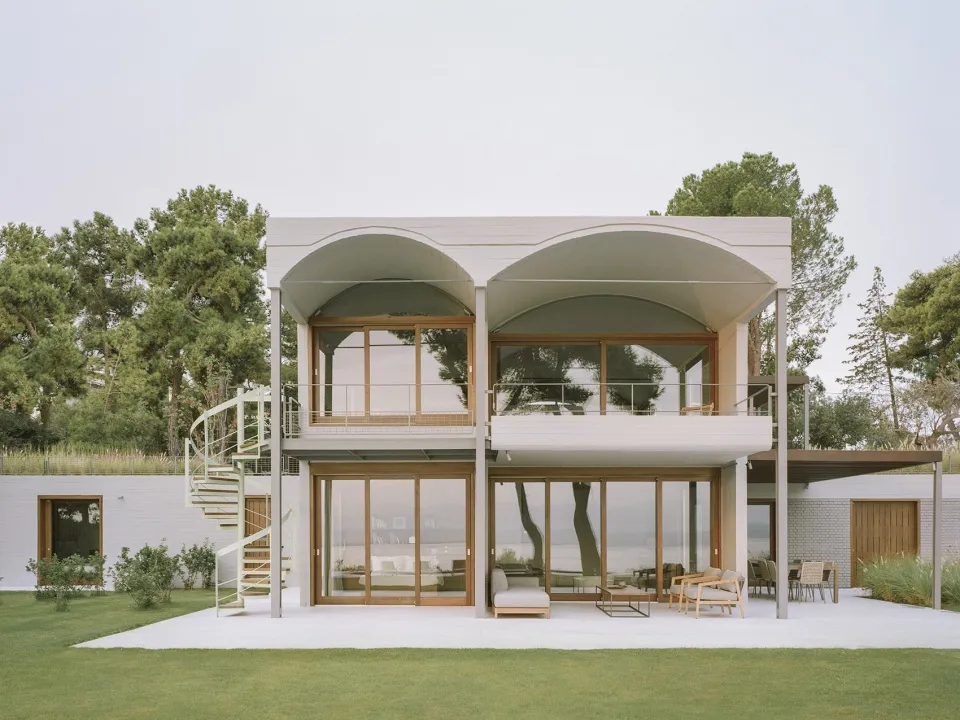 A modern house with concrete, glass, and metal exterior features.