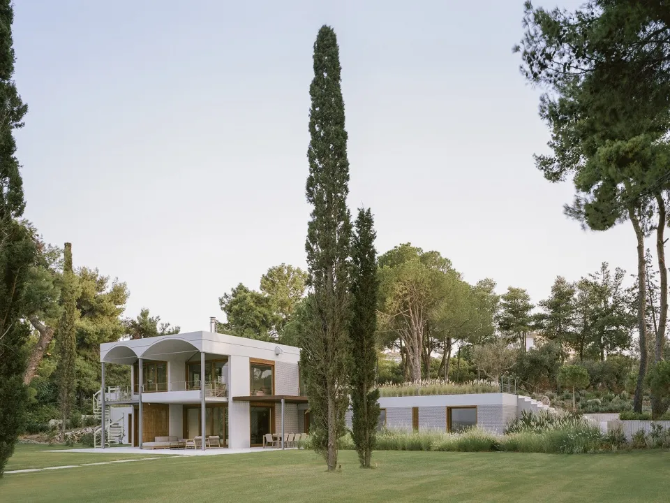 A modern residential exterior featuring concrete materials.