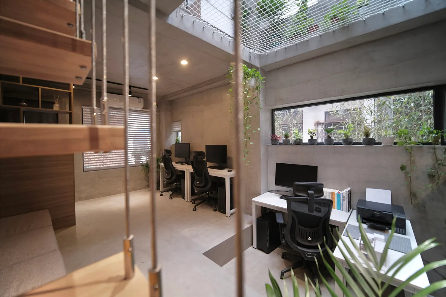 Industrial-style office with concrete walls and wooden furniture