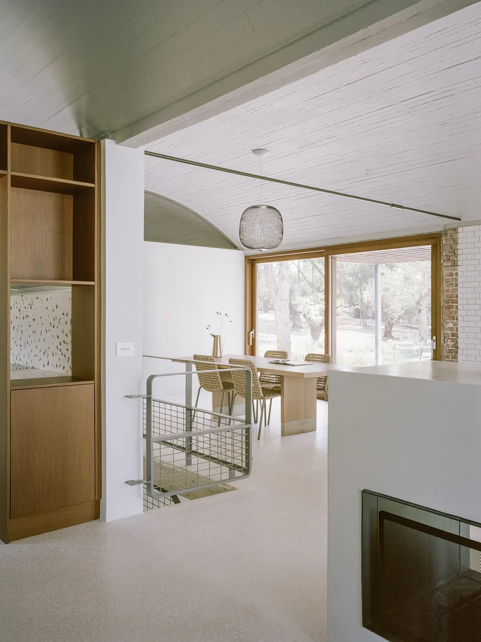 A modern house interior designed with wood and glass materials.