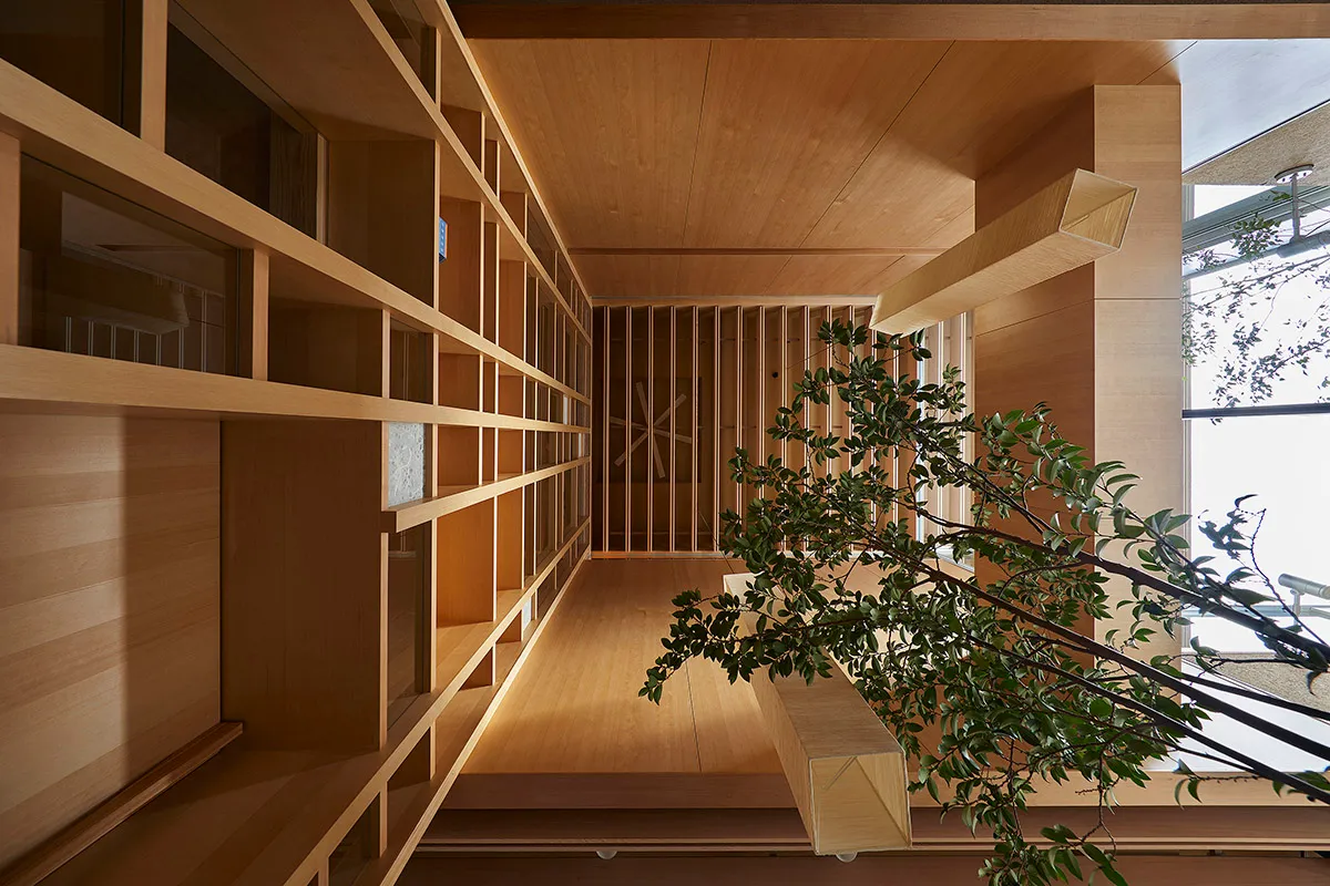 Modern living room with wooden walls and floor, featuring a combination of glass and wood panels.