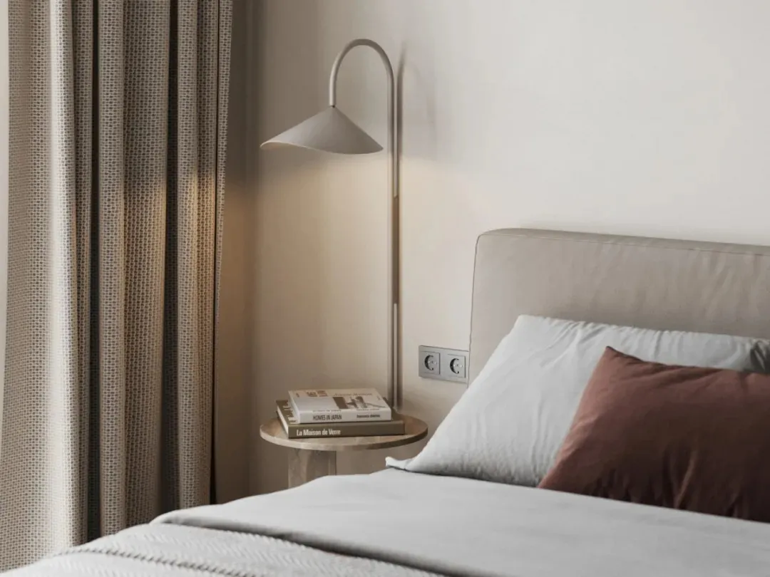 A neatly made bed with light gray bedding and a textured cotton blend fabric headboard, featuring modern minimalist design el