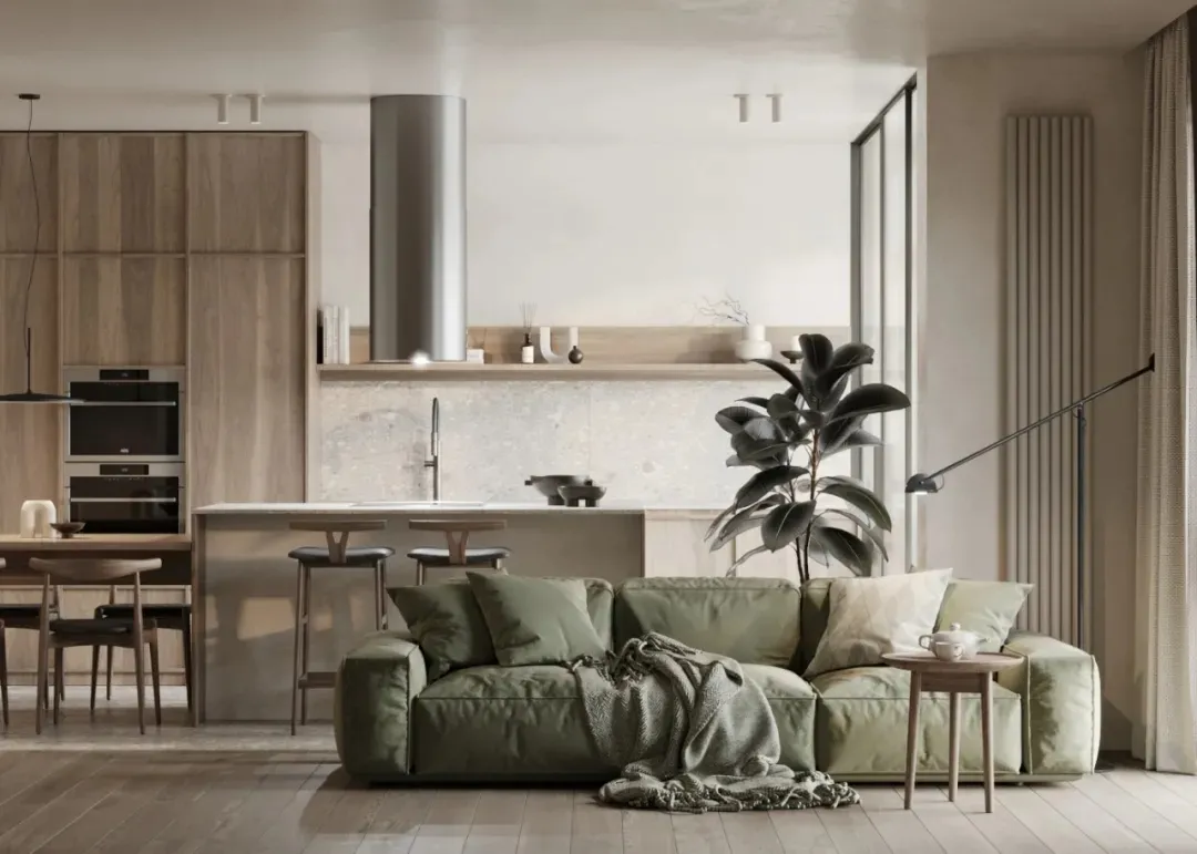 Minimalist living room with modern green upholstered couch, wooden flooring, and a modern kitchen area with wooden cabinets a