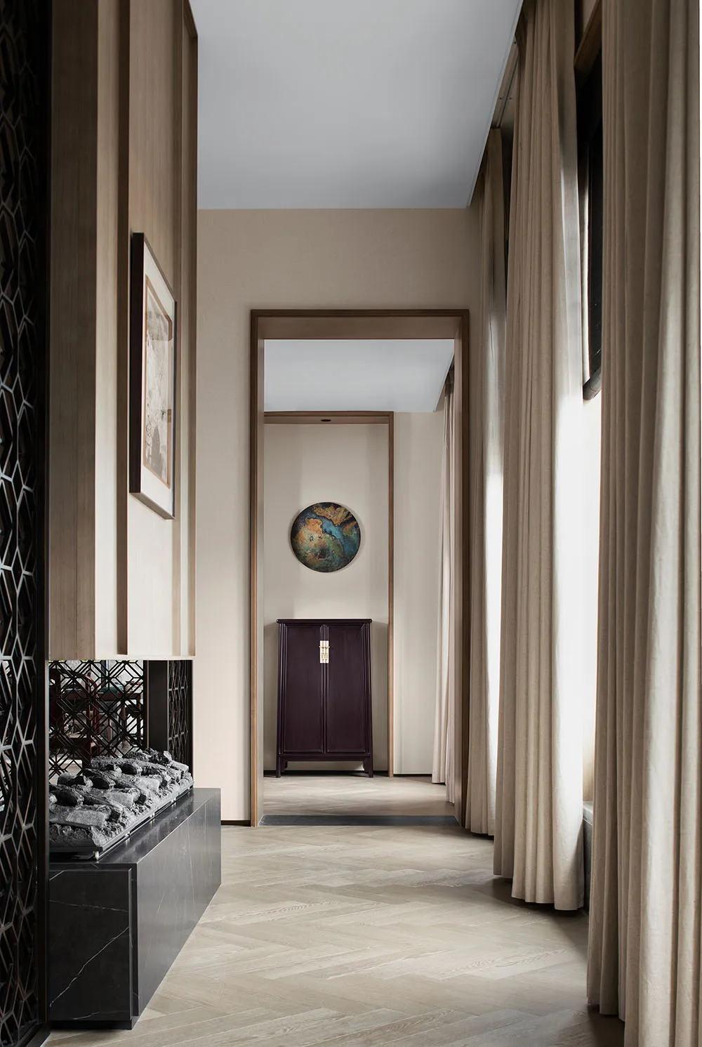 Modern hallway with a wooden floor, warm-toned walls, and fabric curtains.
