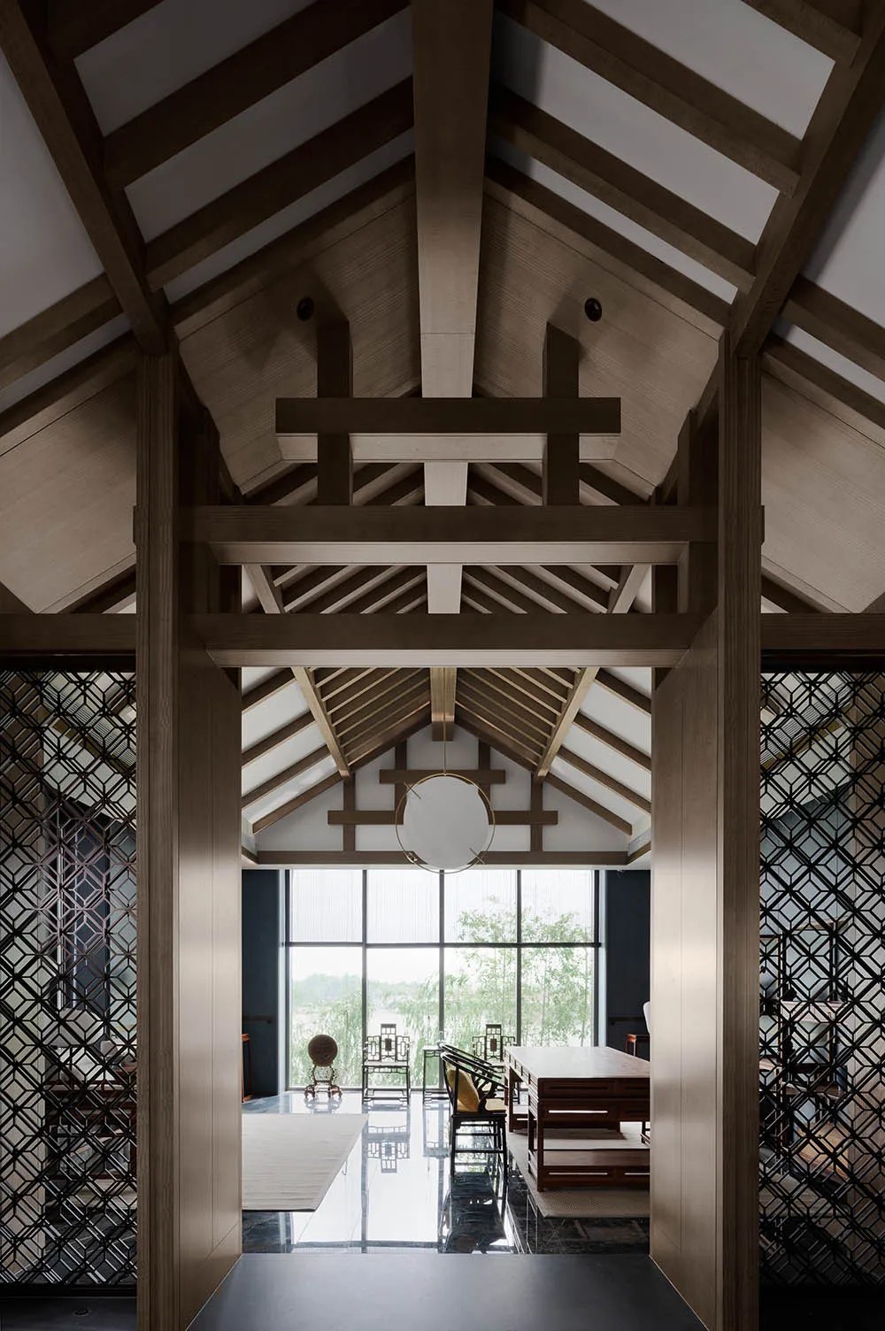 Modern living room featuring wooden elements and large windows with a glass door.