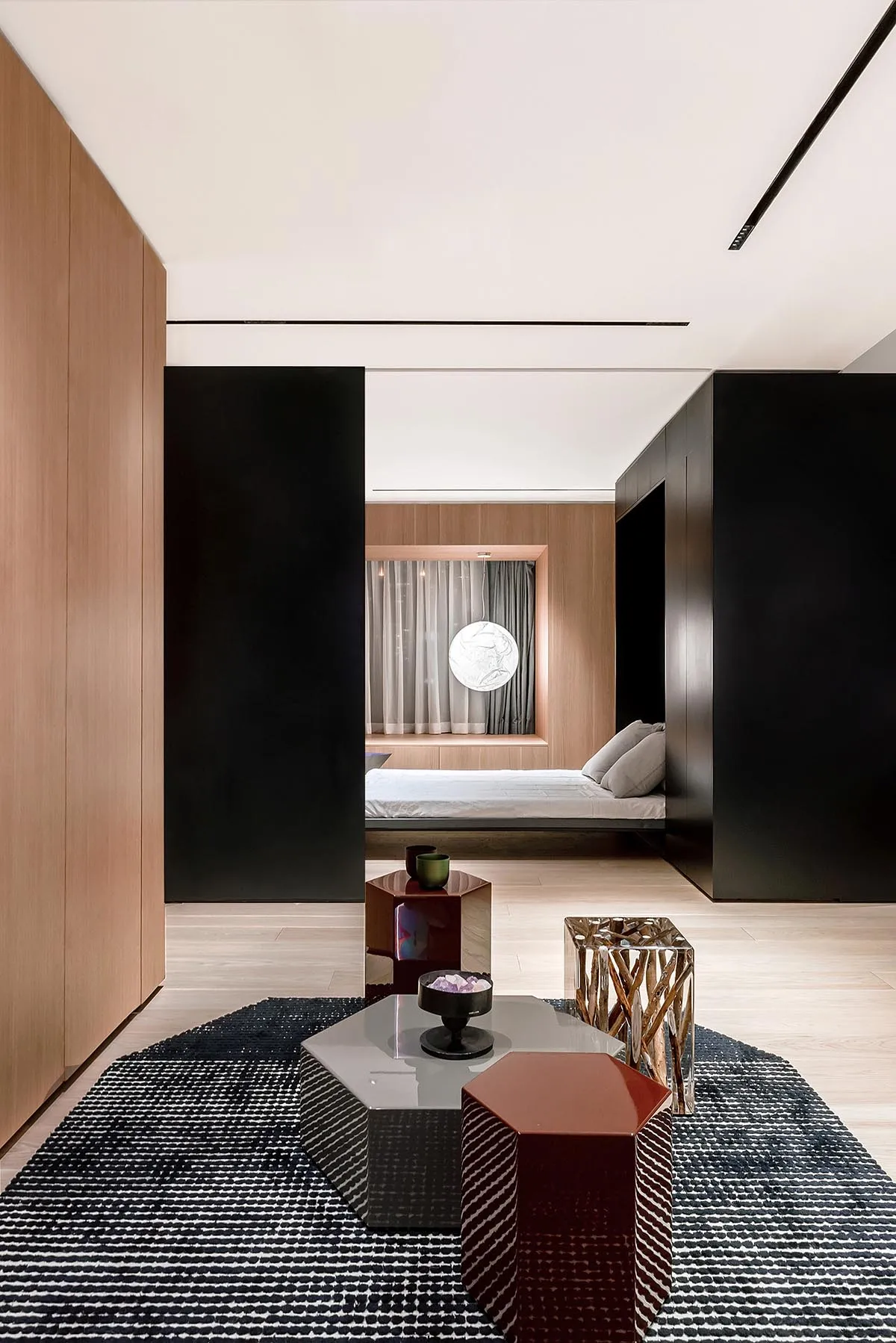 Modern living room featuring wooden walls, hexagonal coffee table, and contemporary furniture.
