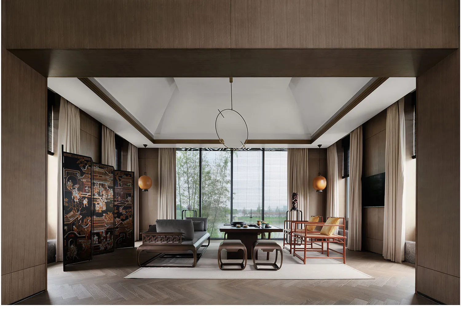 Modern living room with wooden furniture, fabric seating, and glass elements.