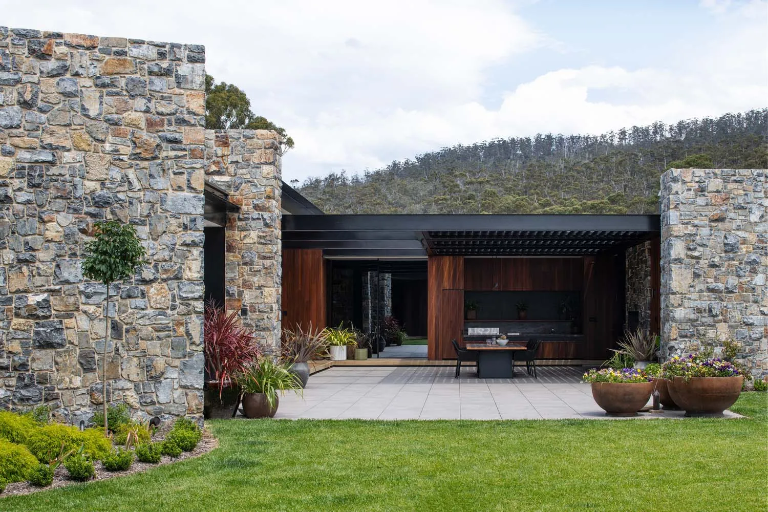 Modern residential exterior featuring stone landscaping.