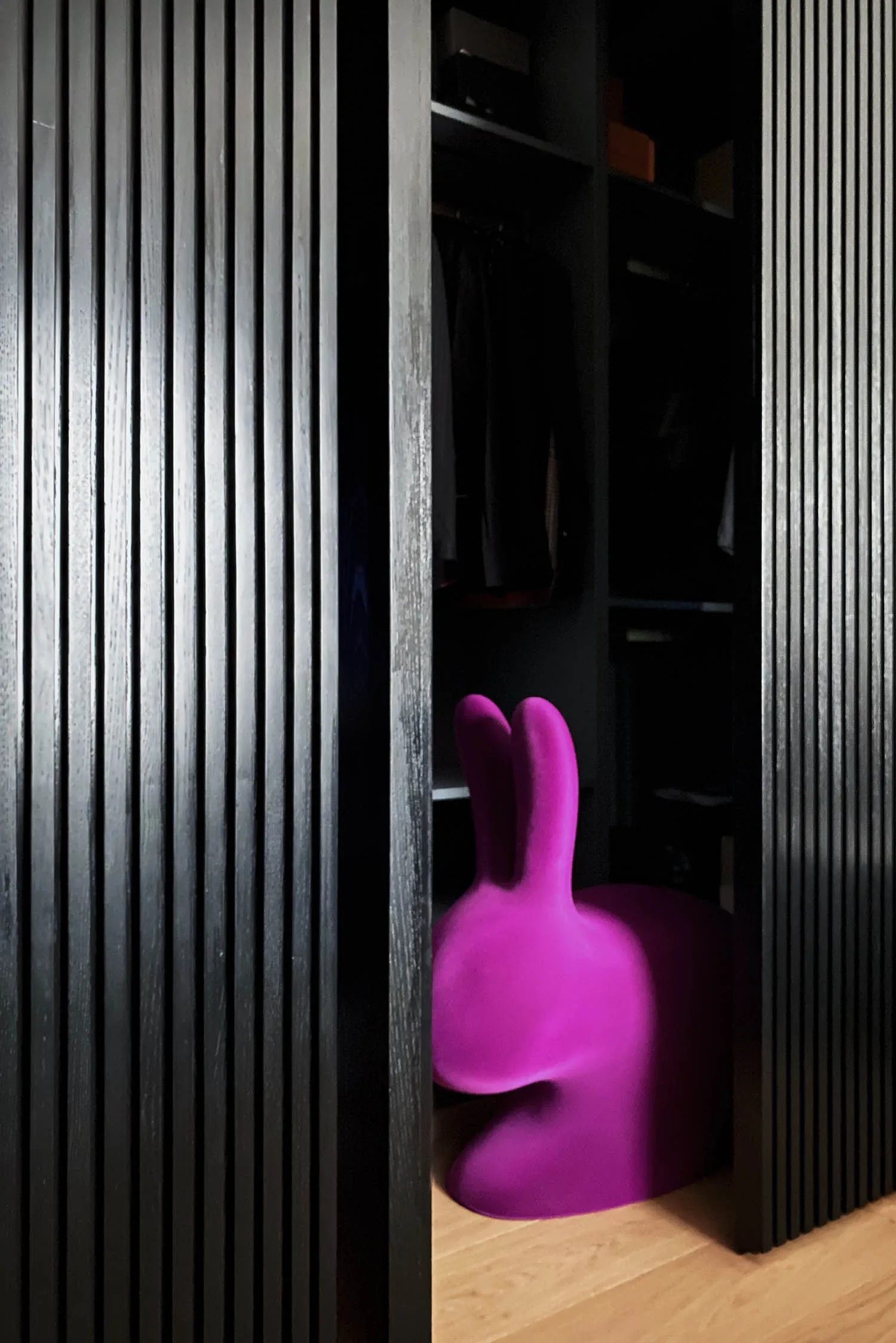 Modern purple bunny chair in a wooden closet
