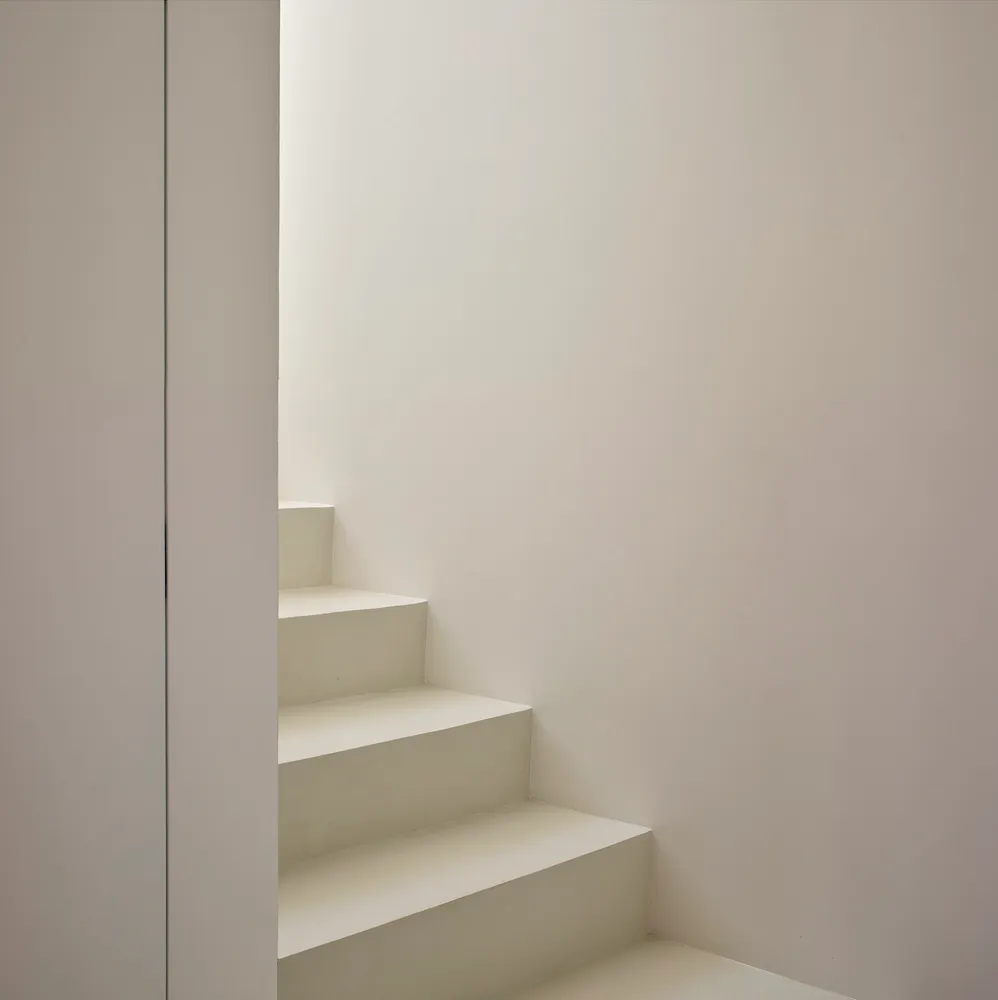 Concrete staircase with white walls in a minimalist interior design.