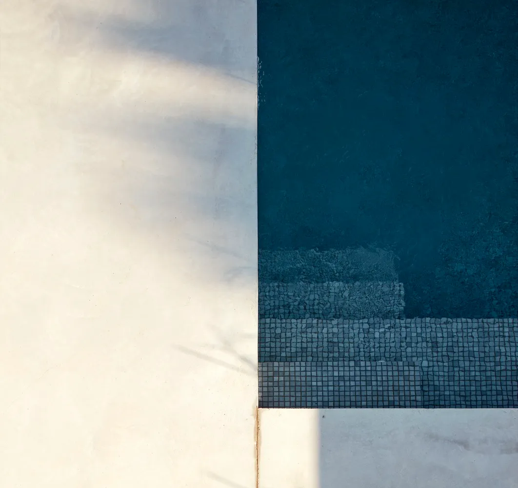 Modern interior design featuring tiles and concrete elements.
