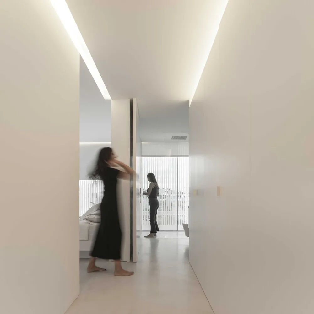 A minimalist interior with white walls and modern design elements.