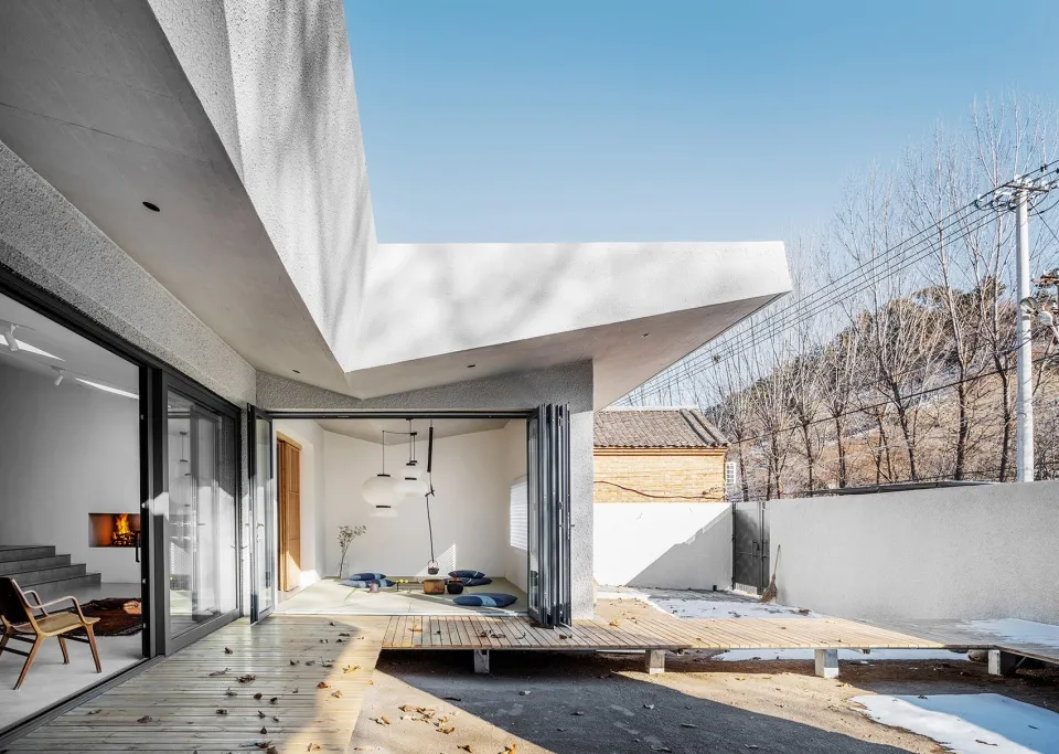 A minimalist residential patio with concrete flooring and a modern aesthetic.