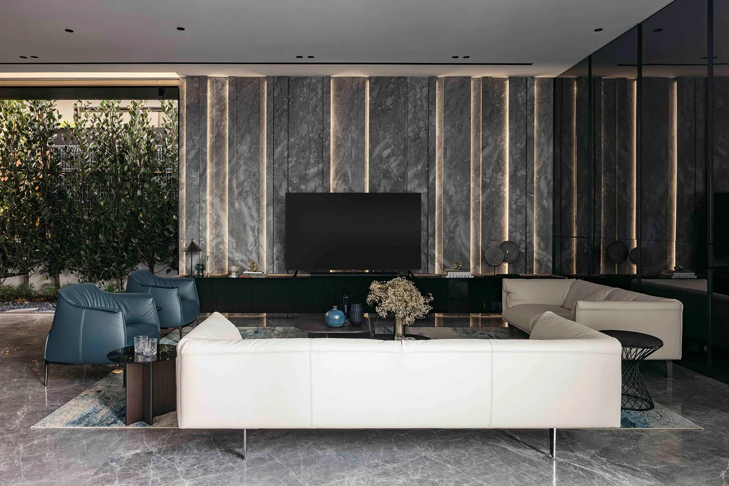 A modern living room with marble accents and a minimalist design.