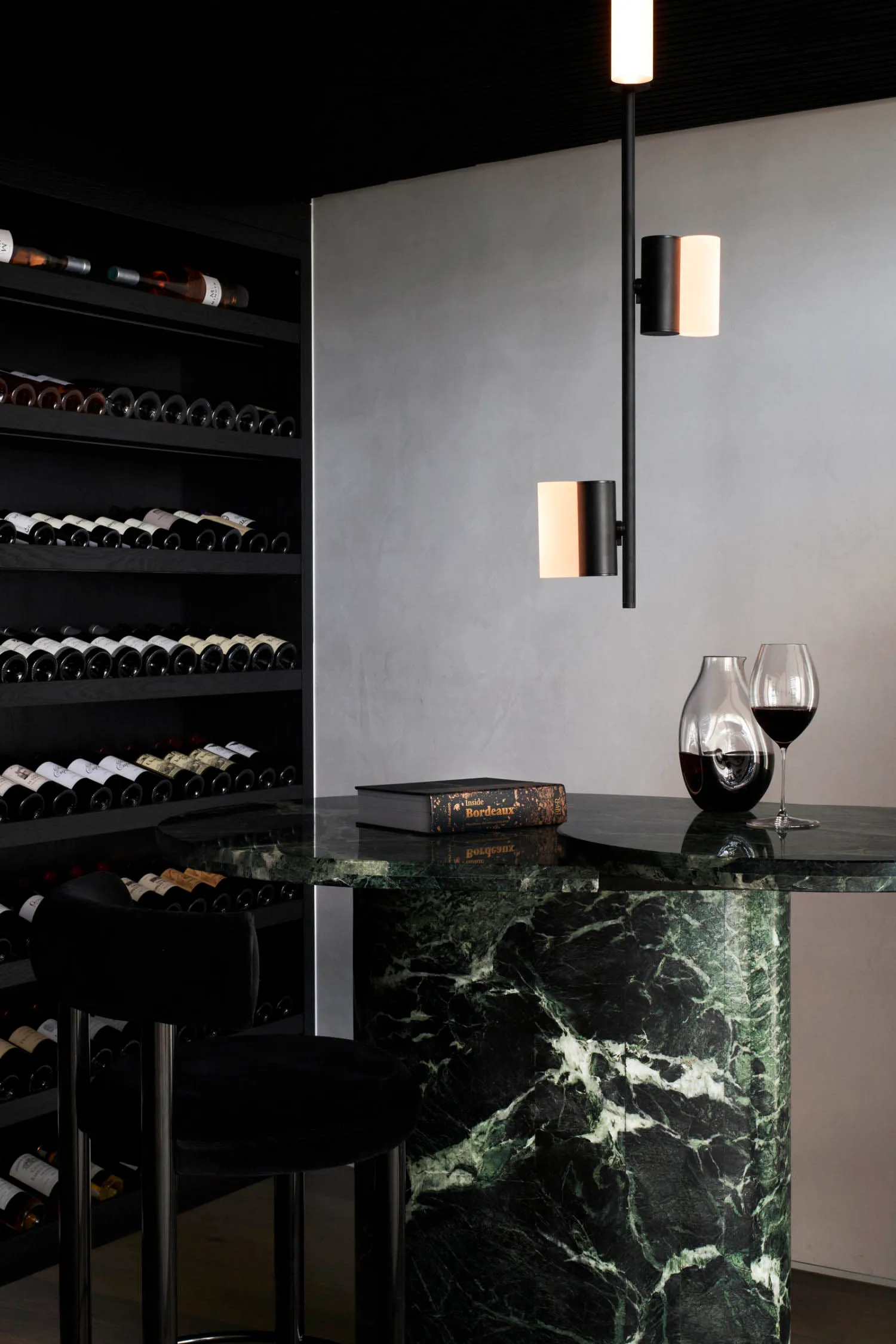 A minimalist bar with a marble countertop and modern lighting fixtures.