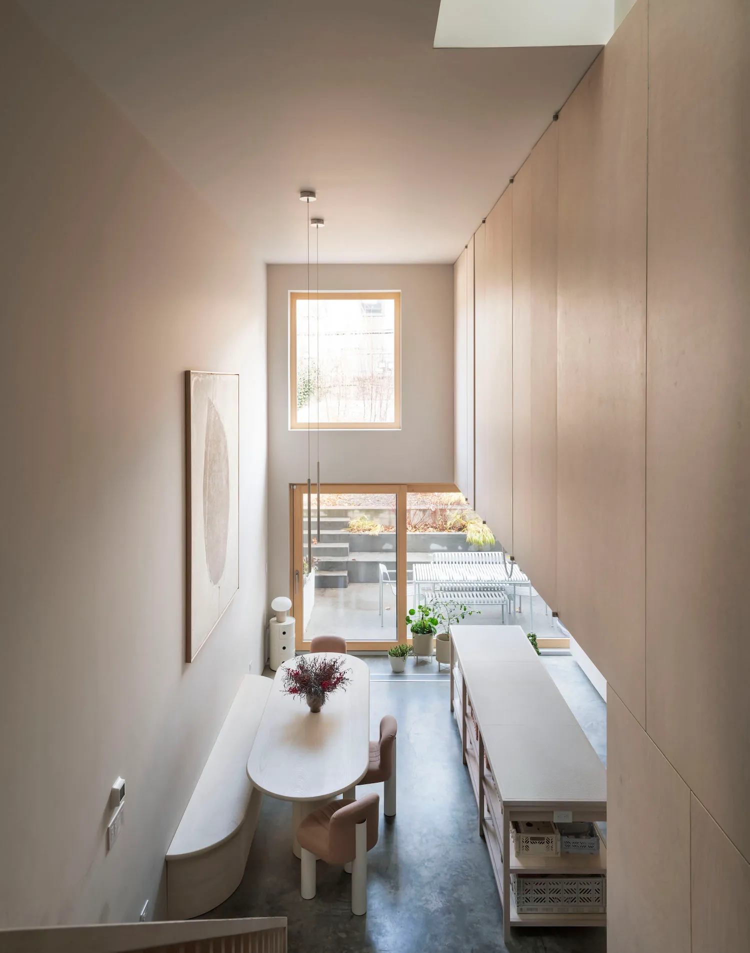 A minimalist dining room featuring modern materials and furniture.