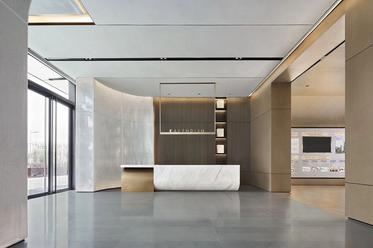 Modern, minimalist commercial lobby featuring marble, wood, and glass materials.