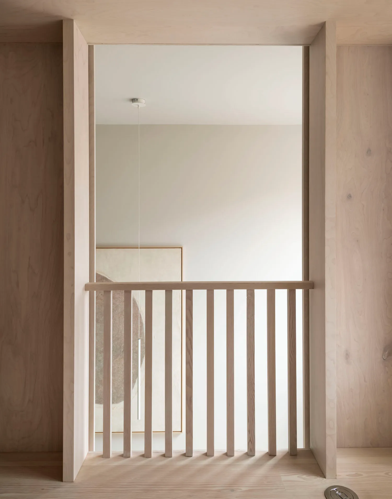 A minimalist interior design featuring light-colored wooden elements.