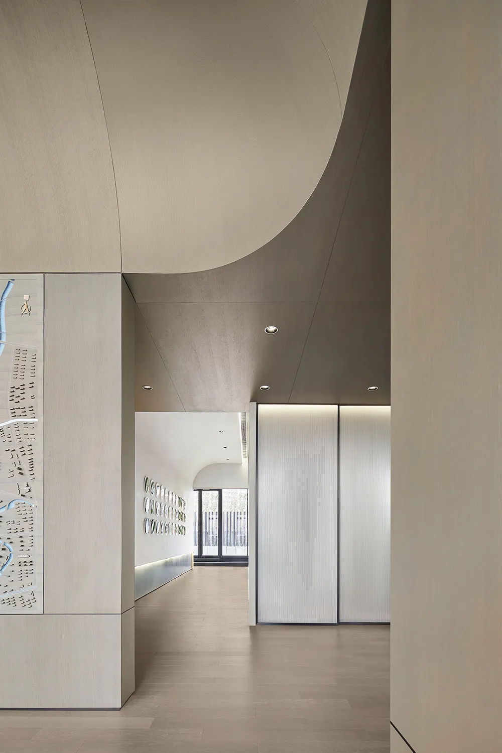 Modern office setting with a metal ceiling and hallway view