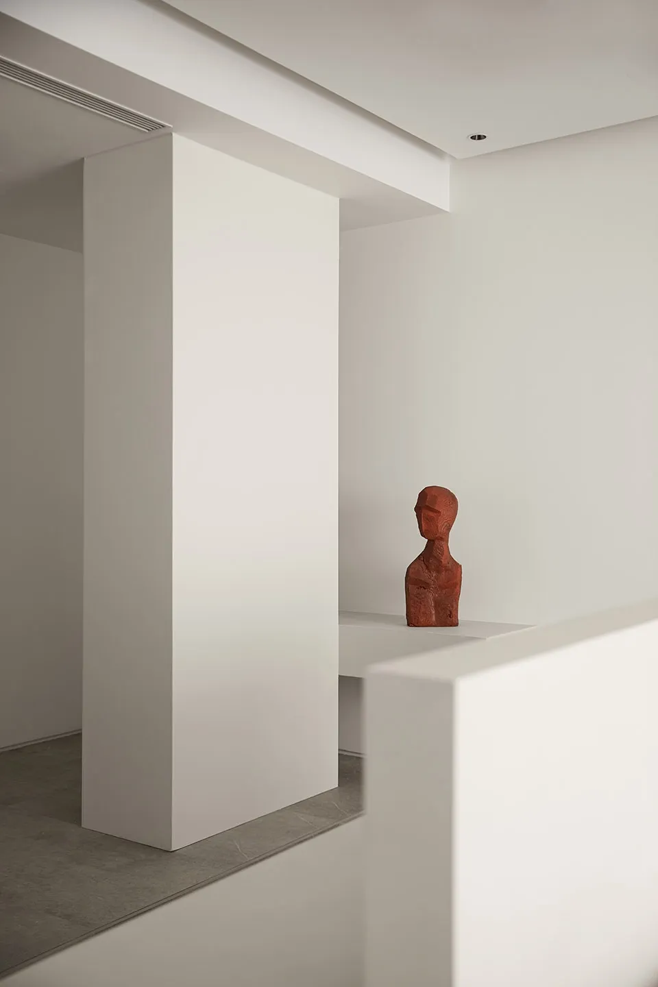 Modern minimalist interior design featuring concrete walls and warm lighting