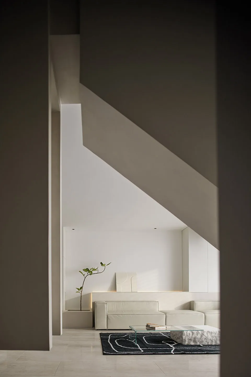 Modern minimalist living room with concrete walls and furniture.