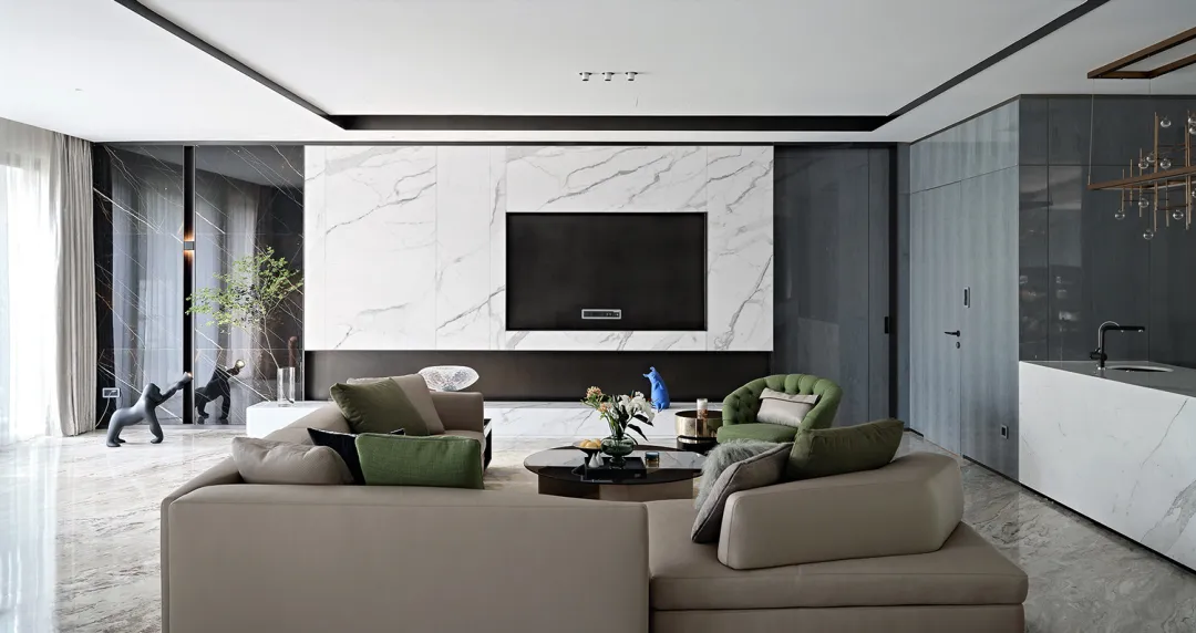 A modern living room featuring a marble wall, comfortable furniture, and a sleek TV setup.